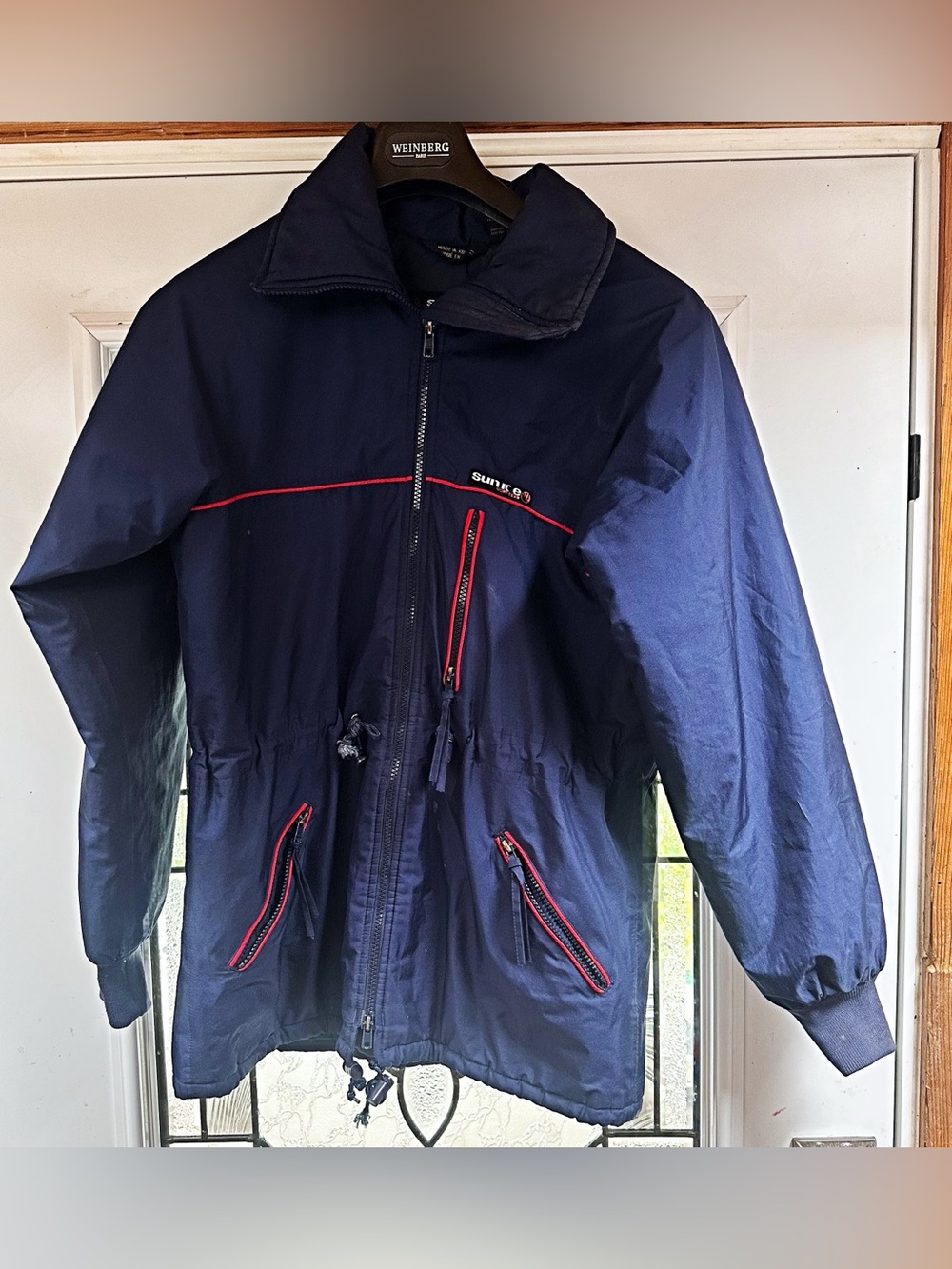 Sunice Navy Windbreaker with Red Trim and Zip Pockets